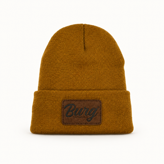 Bronze BURG suede patch sherpa-lined cuffed beanie on a studio background